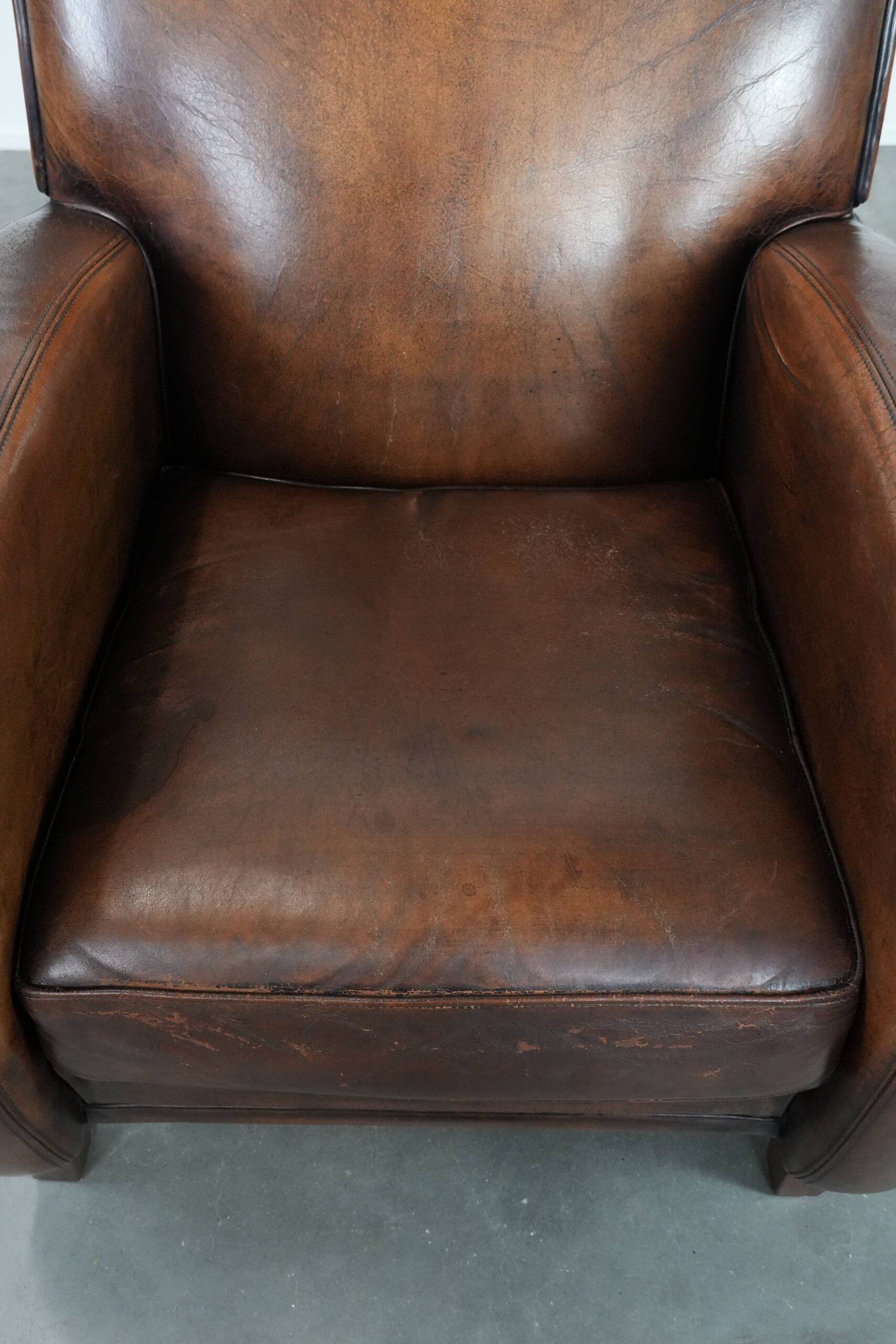 Characterful vintage sheepskin leather armchair with beautiful colours