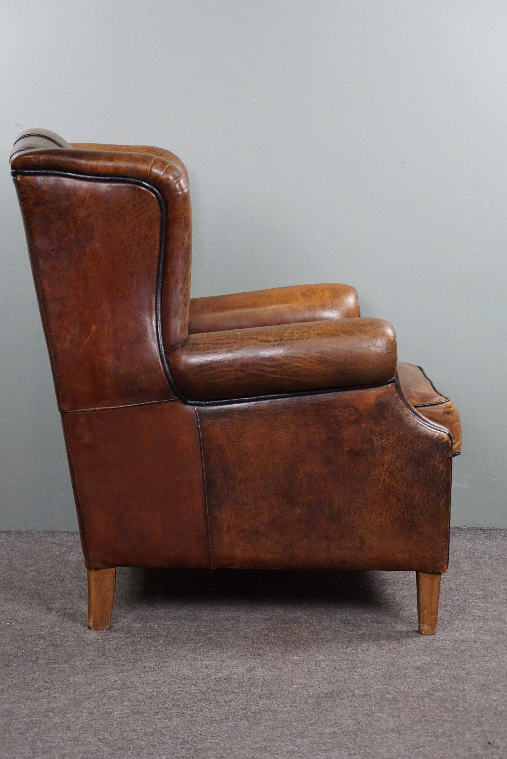 Fauteuil à oreilles en cuir de mouton