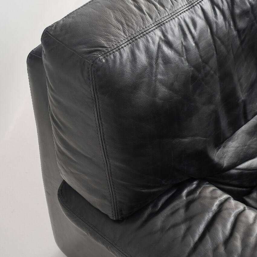 Black leather two-seater sofa. Roche Bobois edition. France, 1980s.