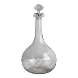 Twisted blown glass carafe with stopper, elegant design.