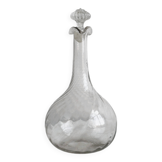 Twisted blown glass carafe with stopper, elegant design.