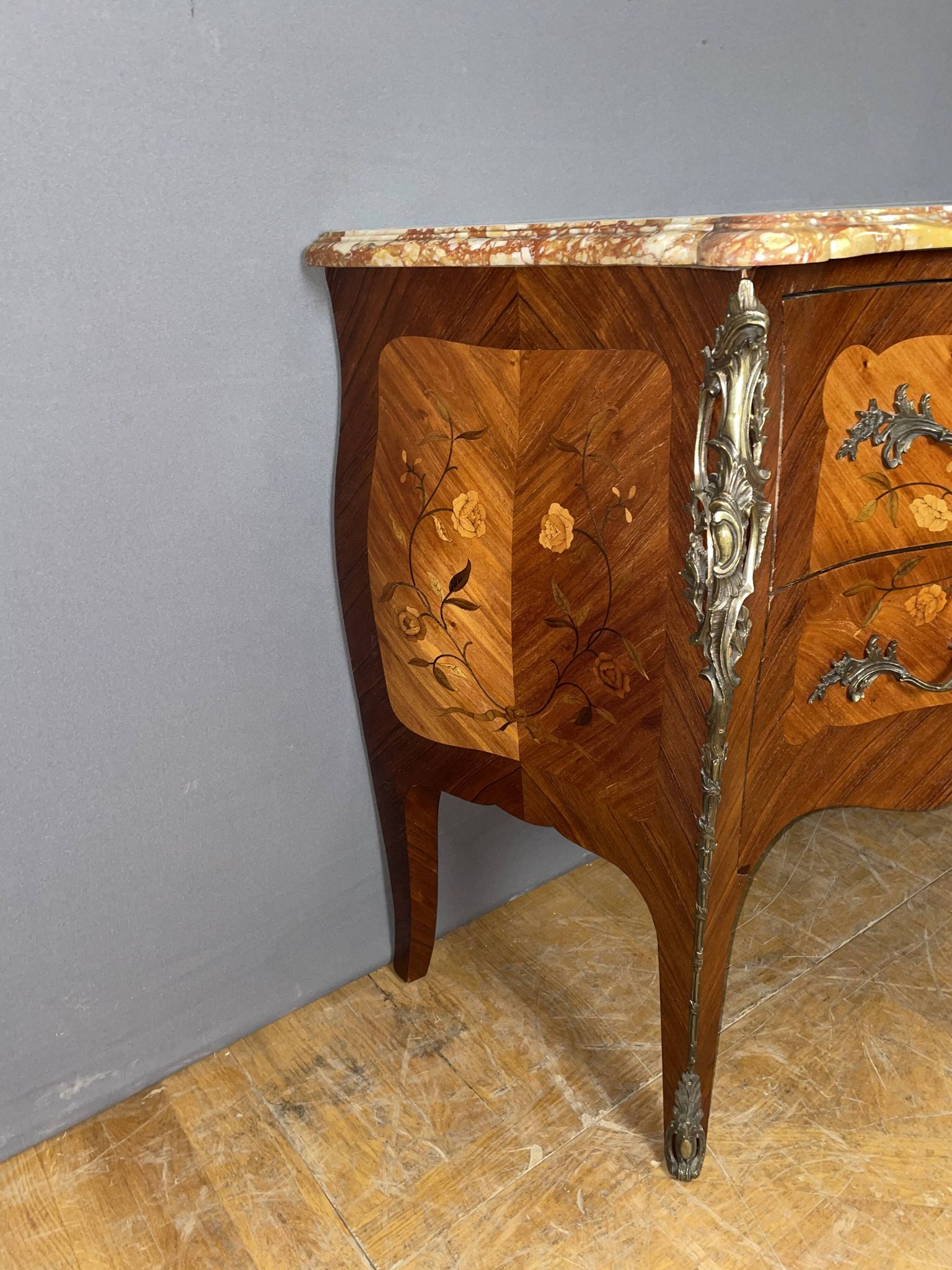 Louis XV style commode with floral marquetry decoration.