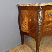 Louis XV style commode with floral marquetry decoration.