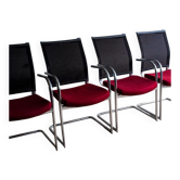Set of 4 cantilever chairs with burgundy seat and mesh backrest.
