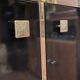 Hollywood Regency style bookcase shelf, gilded brass and black lacquered wood, 1970