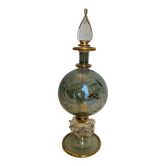 Old perfume bottle in chiseled and gilded glass