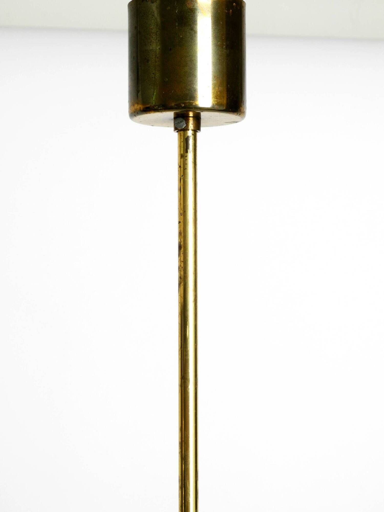 Three staged 18 arm Mid Century brass chandelier with a long brass rod