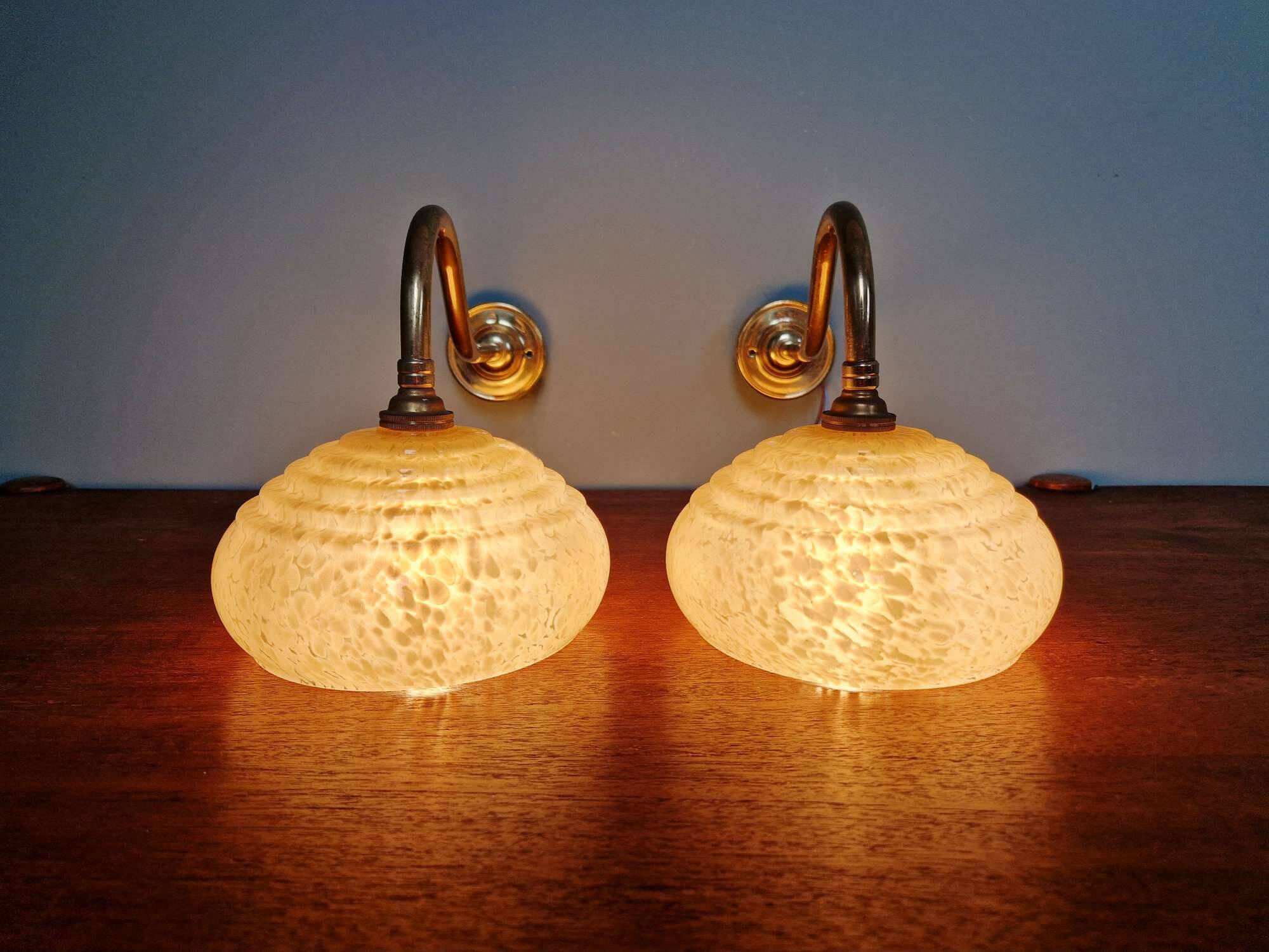 Pair of brass and yellow/white speckled glass wall sconces