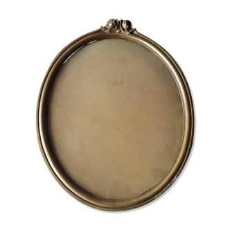 Old nineteenth oval frame in gilded wood