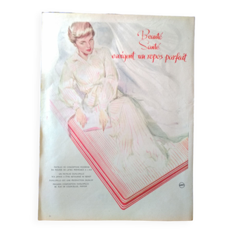 Une publicité d'époque matelas Dunlopillo  issue d'une revue d'époque femme allongée