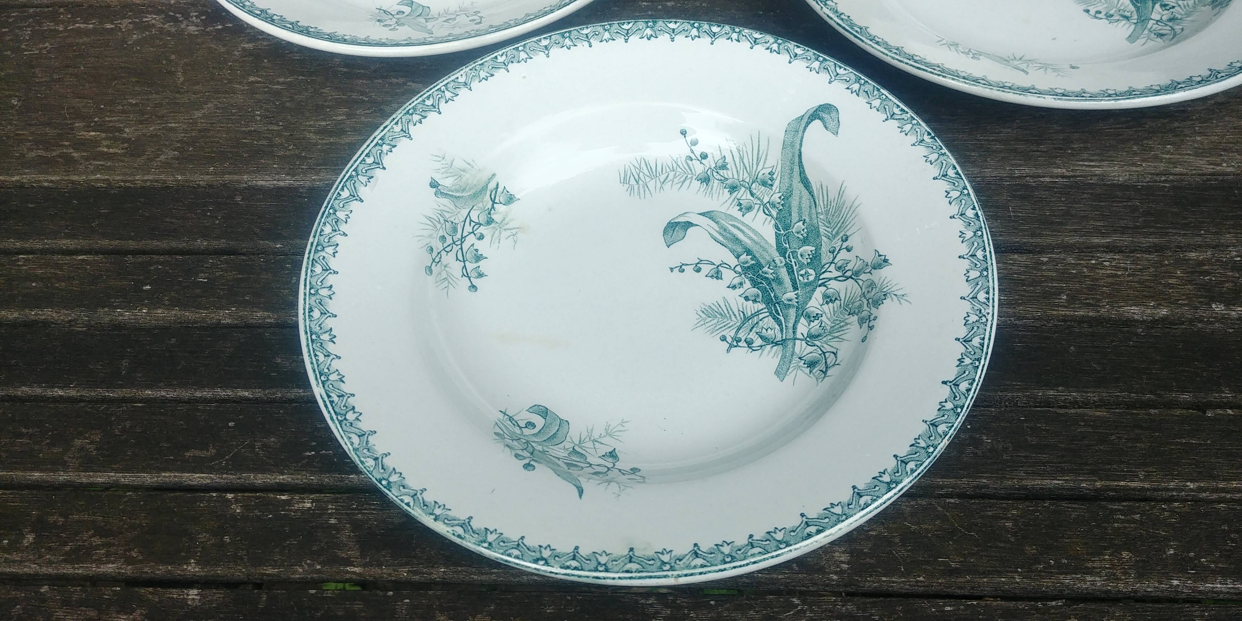 Set of three iron earthenware plates from the St Amandinoise earthenware factory, lily of the valley model.
