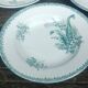 Set of three iron earthenware plates from the St Amandinoise earthenware factory, lily of the valley model.
