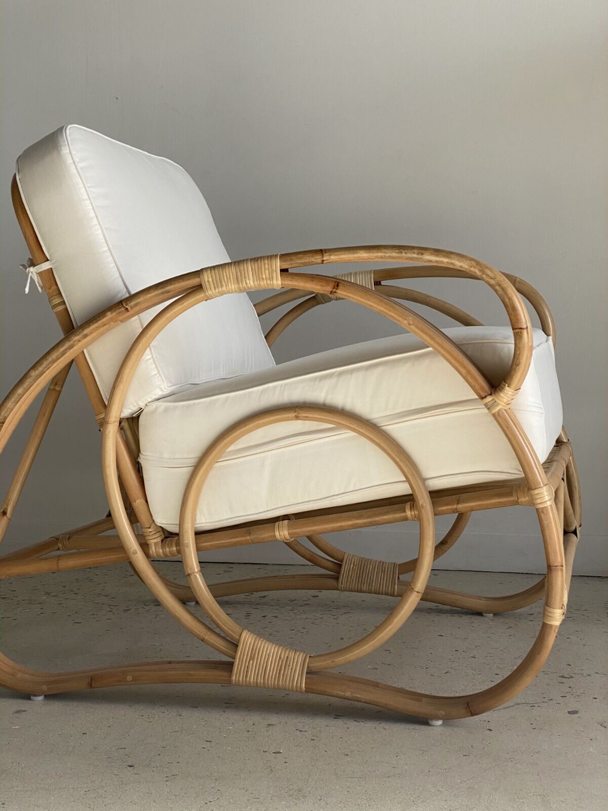 Large rattan rest chair and white cushions
