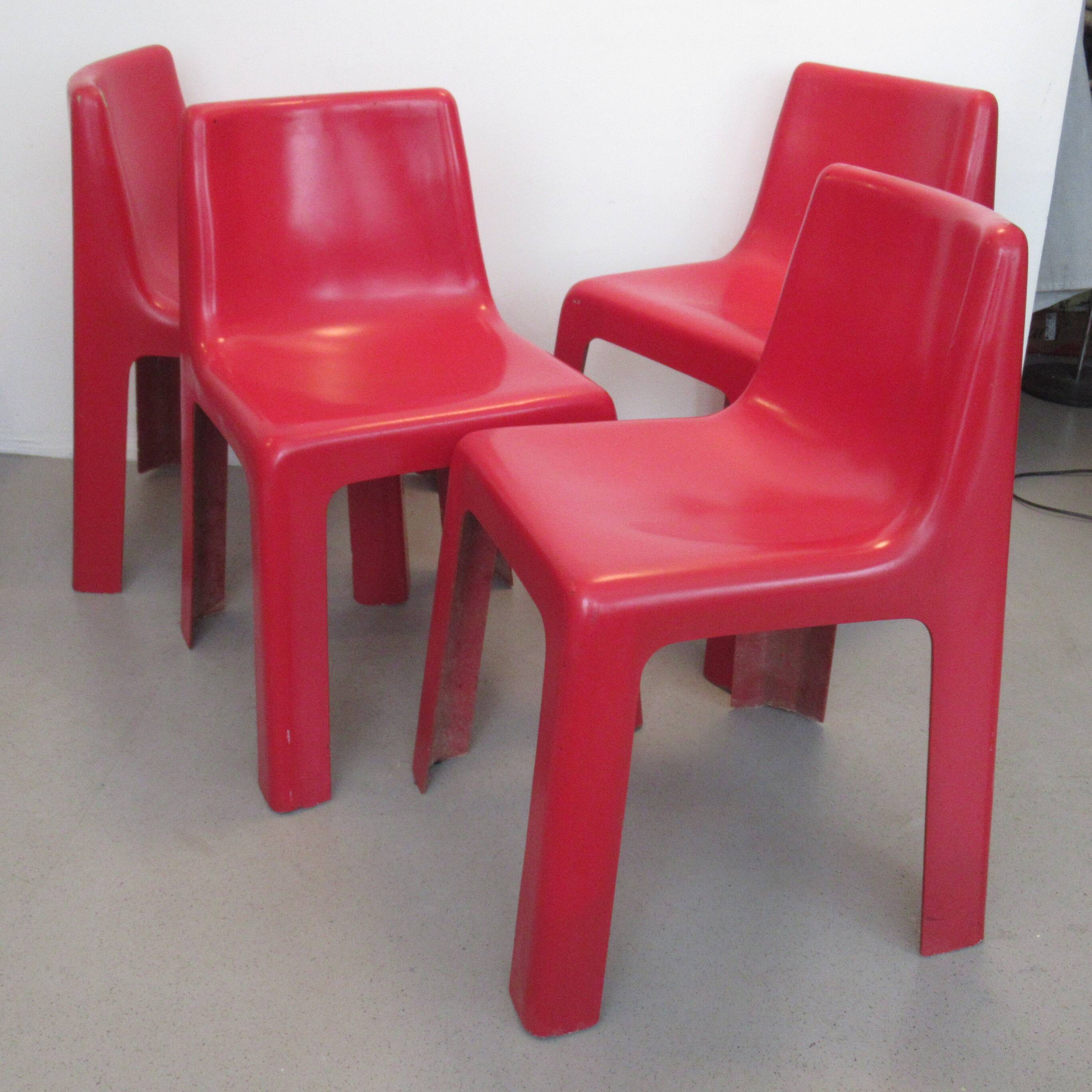 Four red fibreglass chairs from the 1970s.