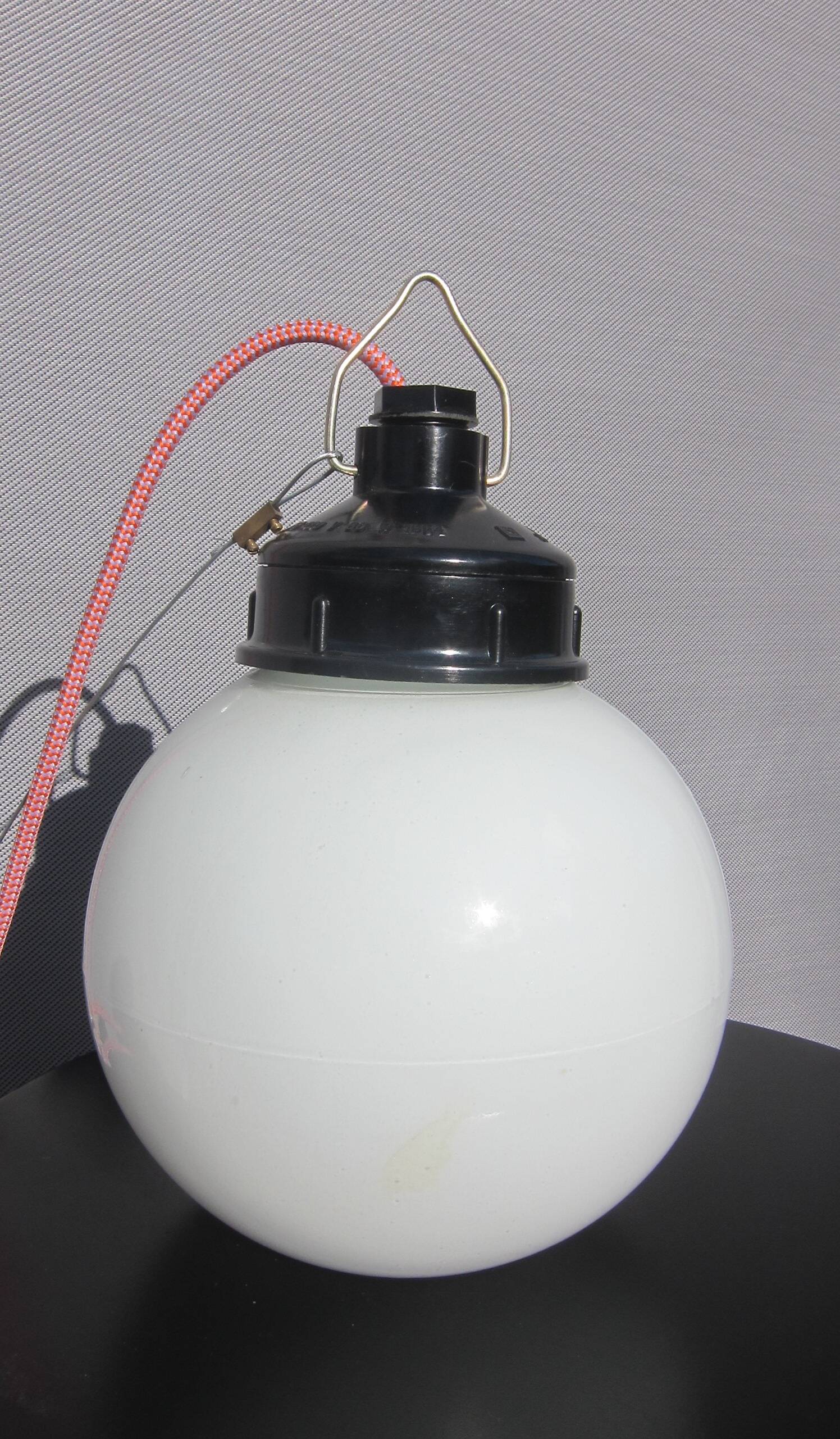 Trio of opal glass and bakelite globe pendant lights