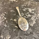 Openwork serving spoon, silver metal