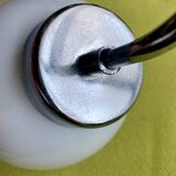 Pair of chrome metal wall lights with white glass globe.