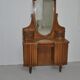 Large vintage brown wooden dressing table with an oval mirror and built-in storage.
