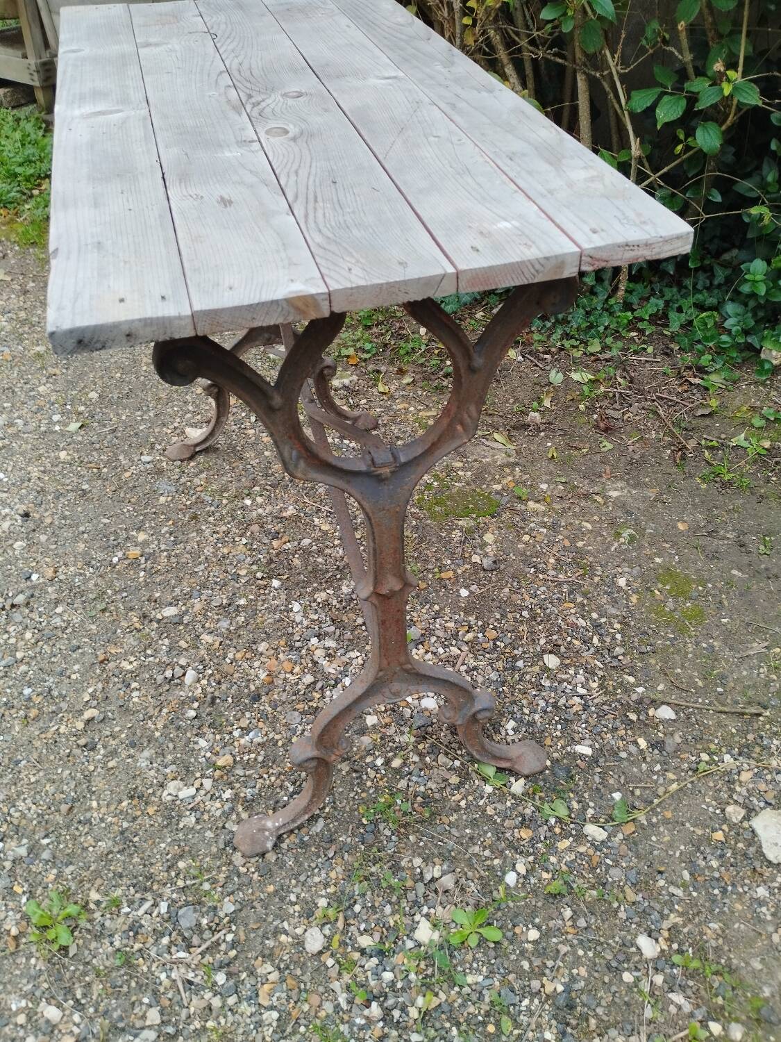 Antique bistro table with iron legs and wooden top