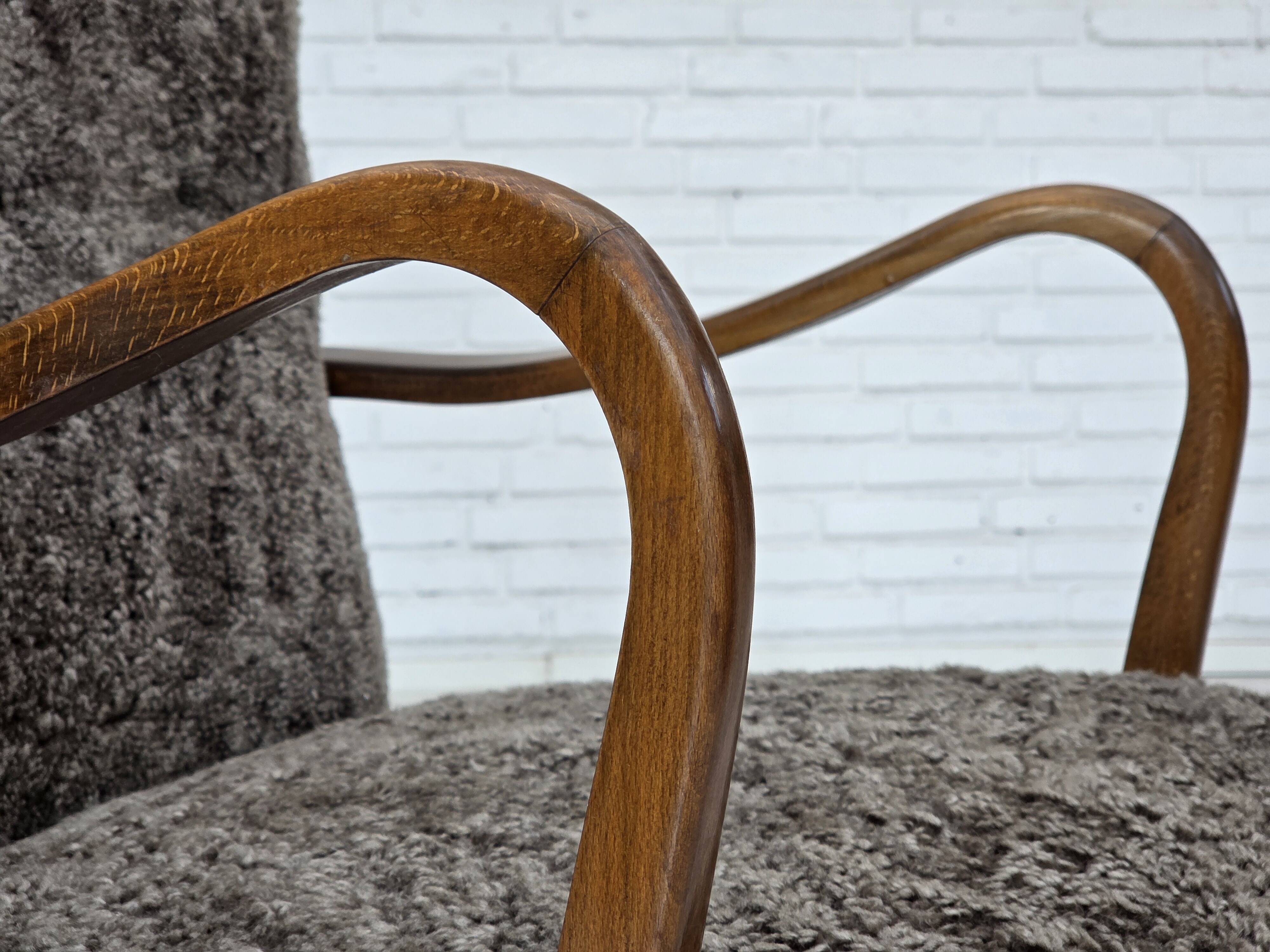 1960s, reupholstered Danish armchair, with stool, genuine sheepskin.