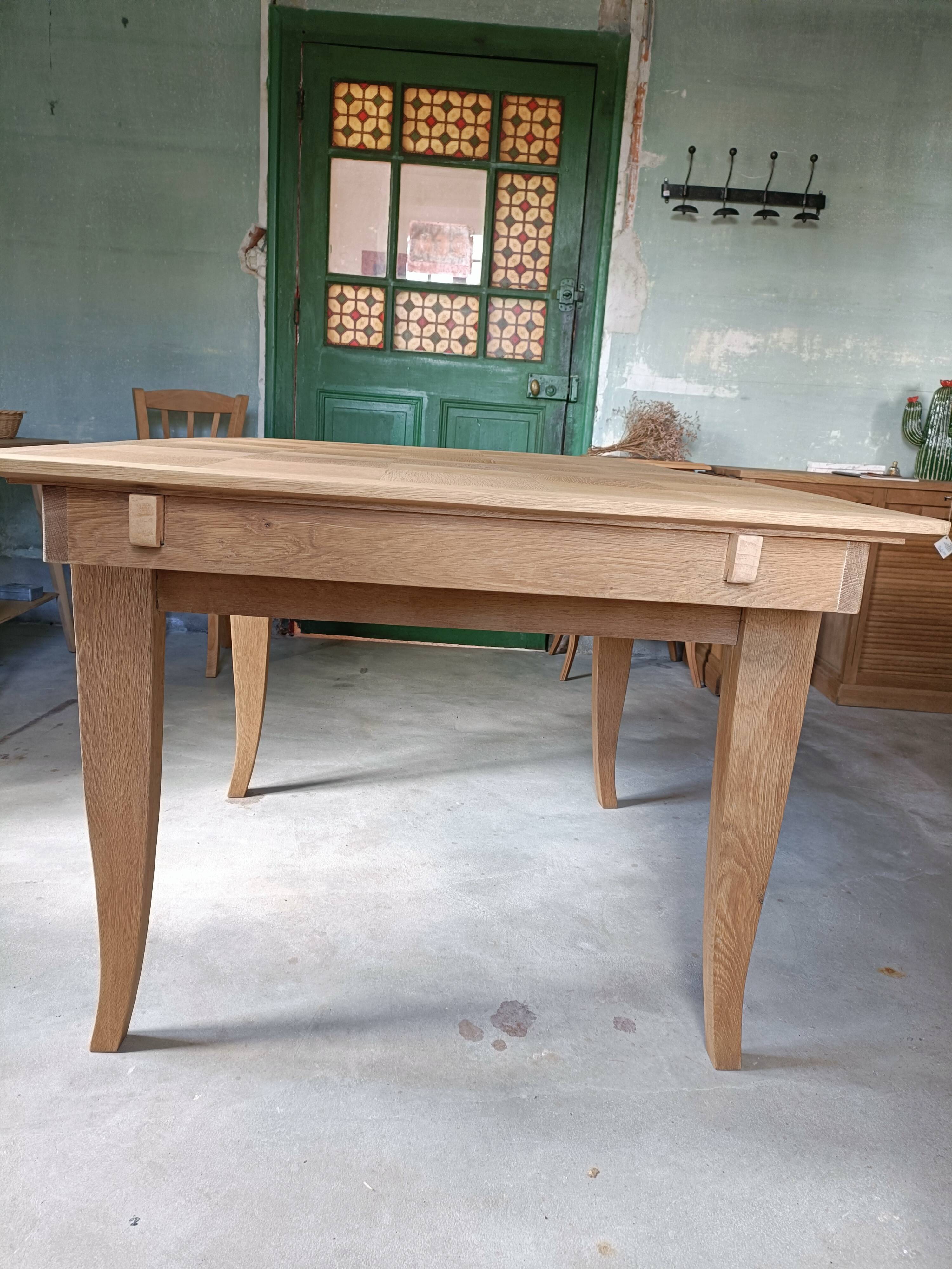 Oak dining table with a checkerboard top and extensions.