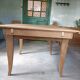 Oak dining table with a checkerboard top and extensions.