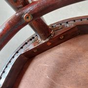 pair of round bistro chairs with a pattern on the seat, vintage