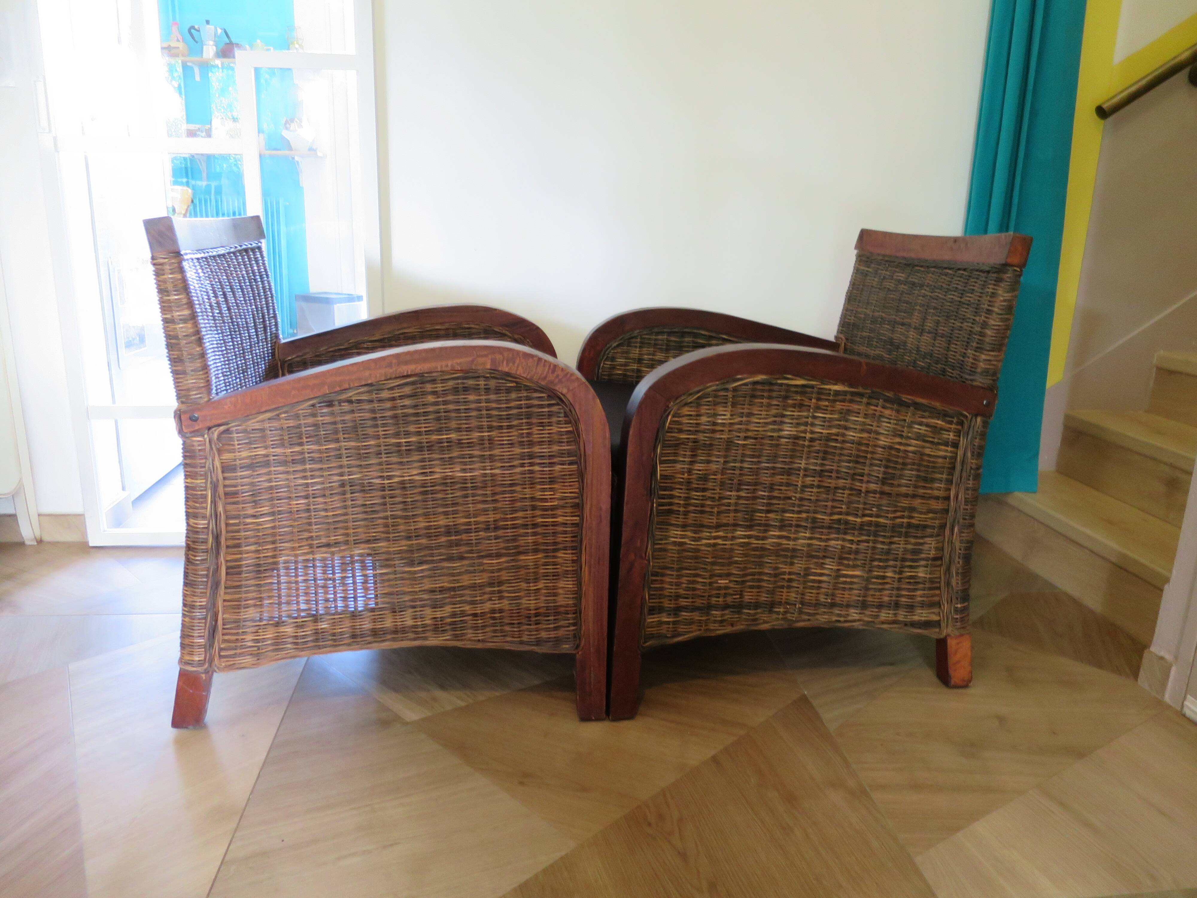 2 colonial-style armchairs in woven rattan and exotic wood