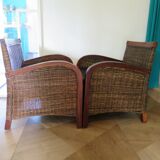 2 colonial-style armchairs in woven rattan and exotic wood