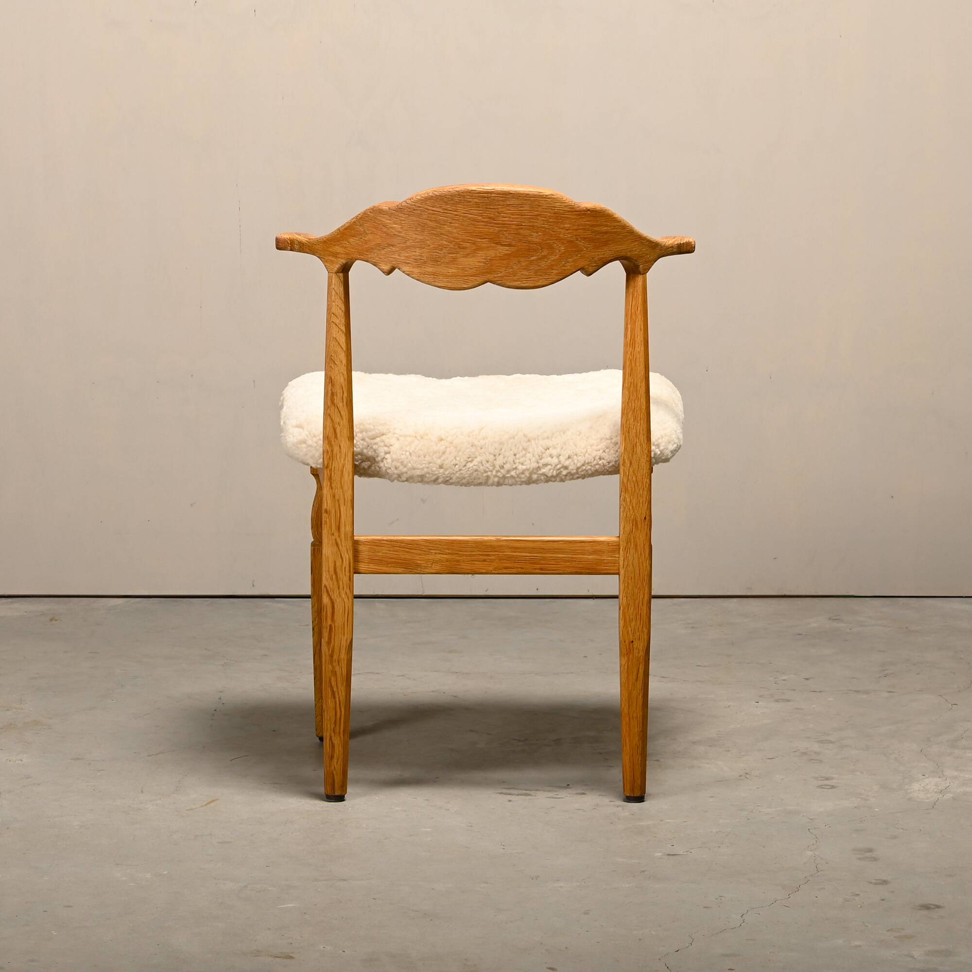 Henning Kjærnulf dining chairs set in Oak and Sheepskin, Denmark, 1960s