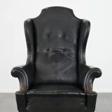 Antique black English cow leather wingback armchair from the 19th century