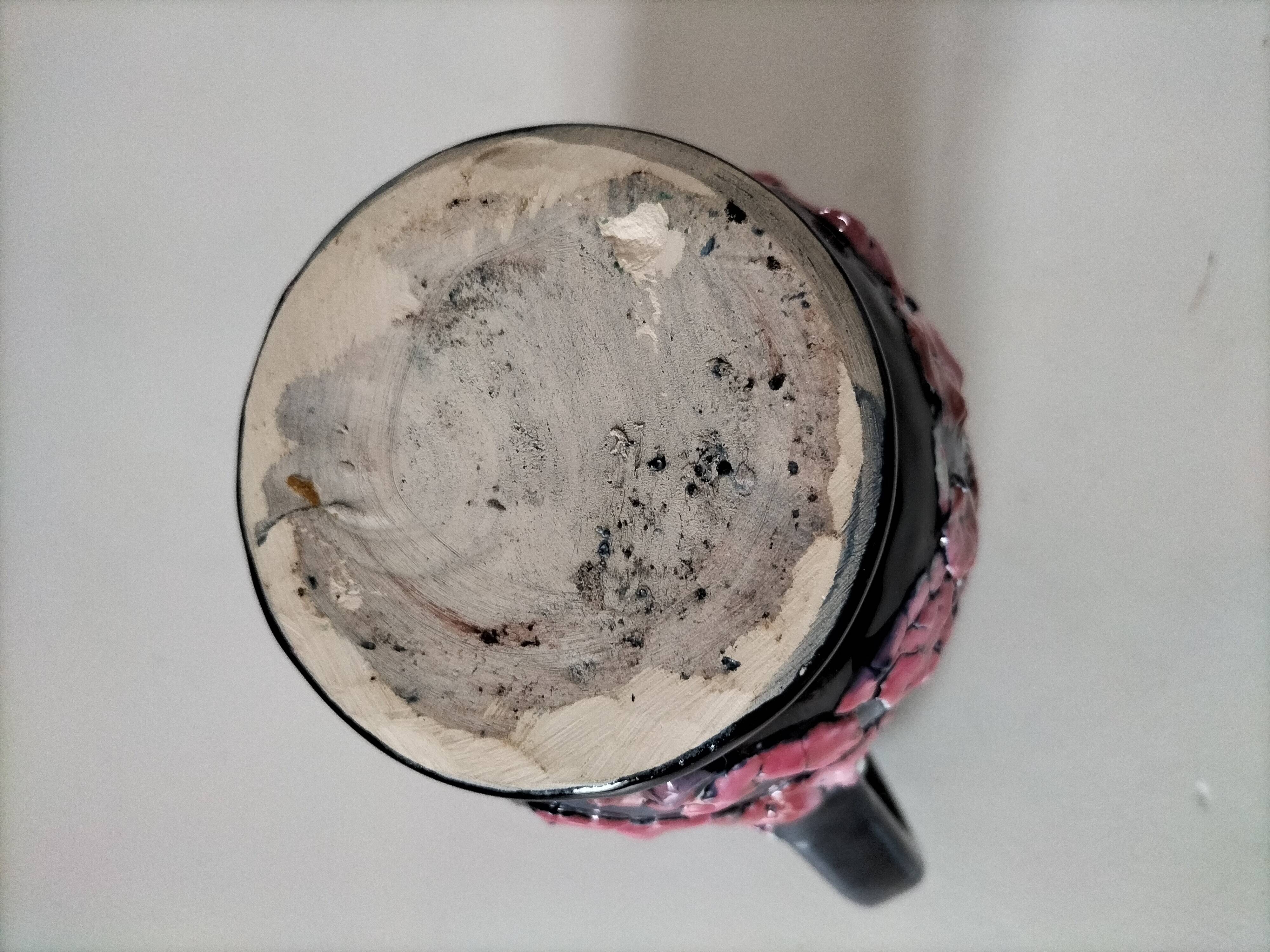 Vintage pitcher in midnight blue glazed ceramic with bright pink relief