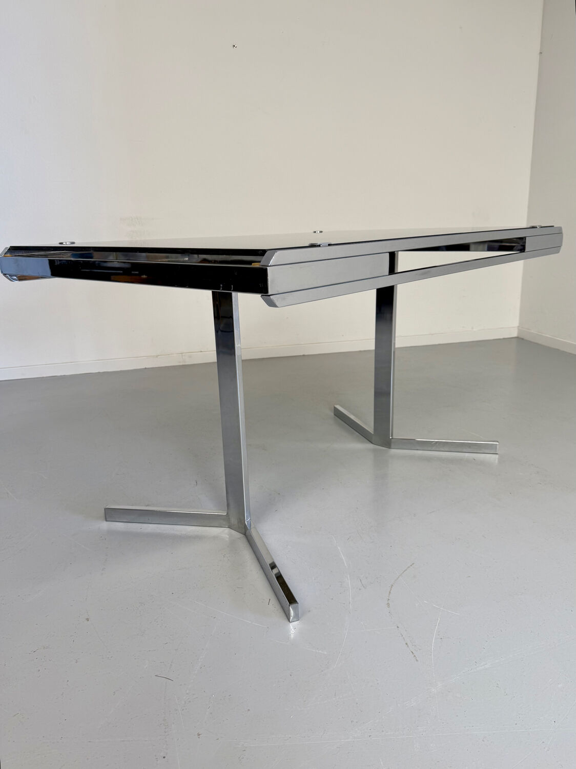 Smoked glass dining table with chrome legs, 1970s design by Roche Bobois.