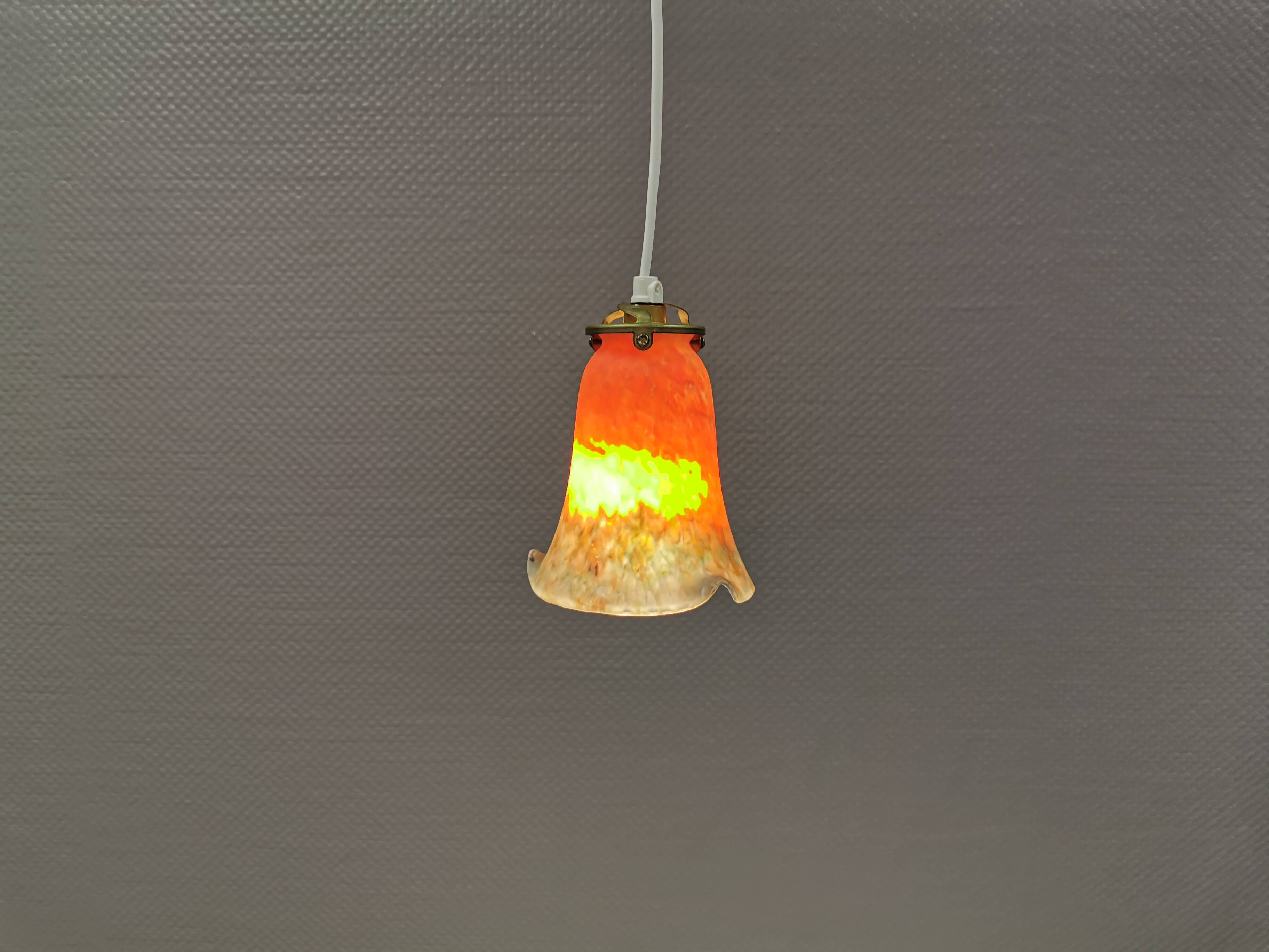 Small, beautiful hanging lamp in Art Deco style with brass top.