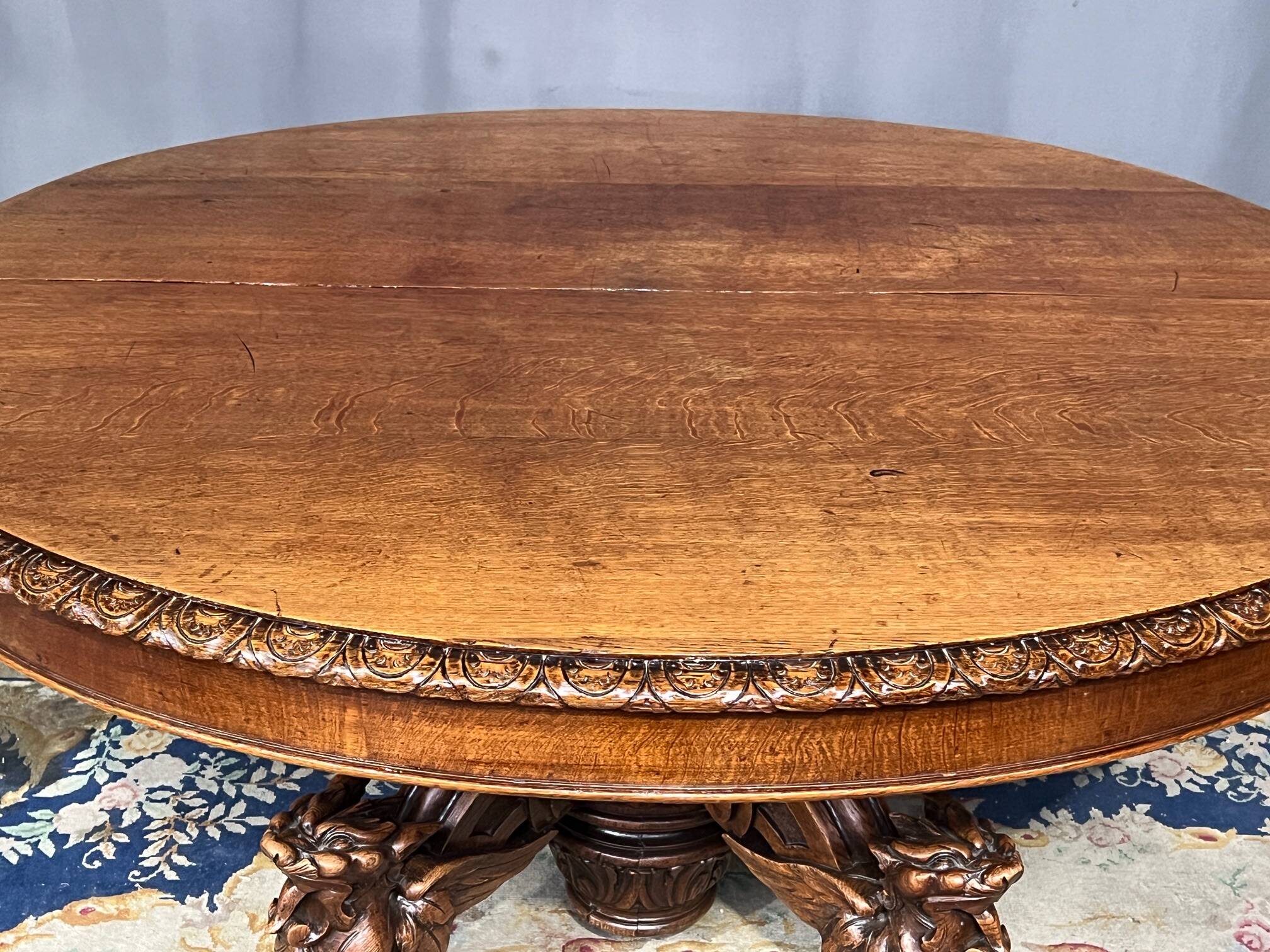 Large extendable dining table in hunting style with four fox figures on the leg.