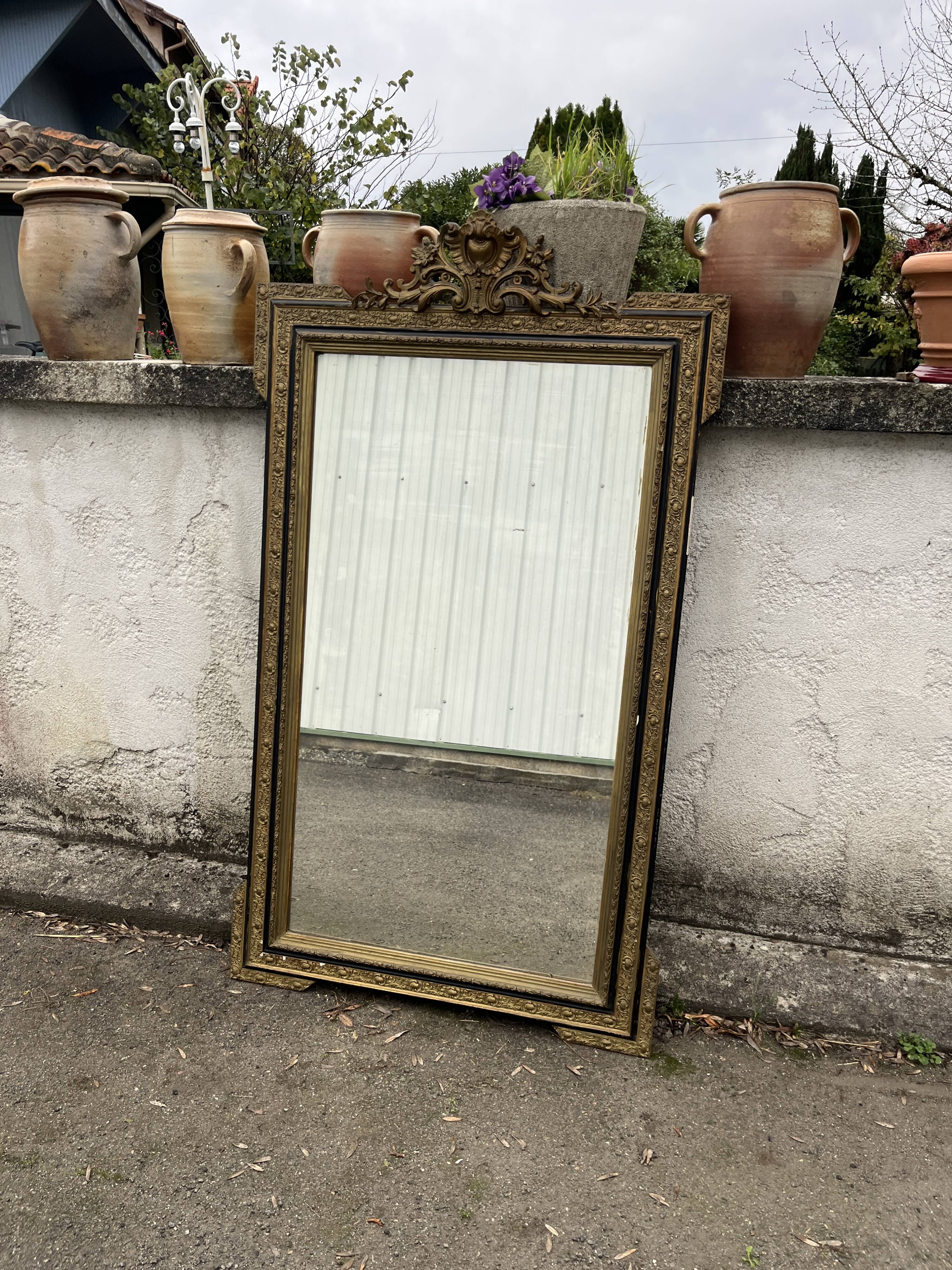 Large antique gilt mirror with scroll and shell decoration, 144 cm