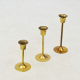 A set of three golden candlesticks, 1970s