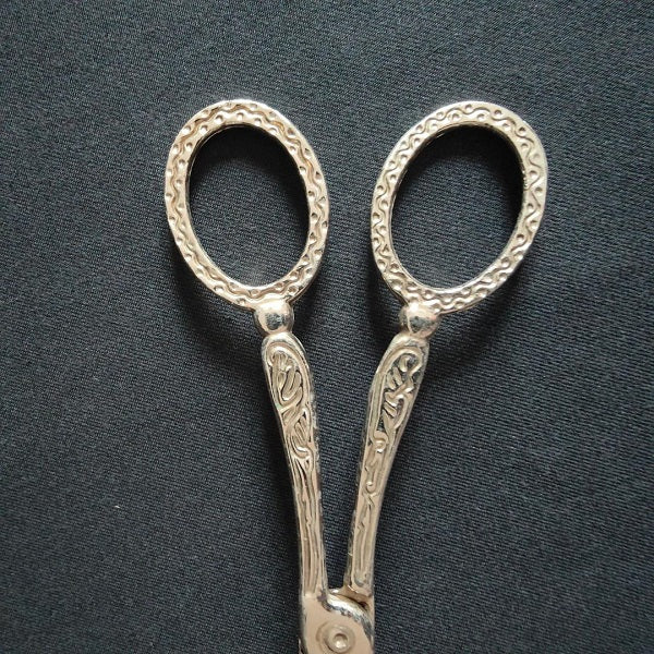 Engraved metal cake pliers