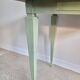 Green side table with tapered legs