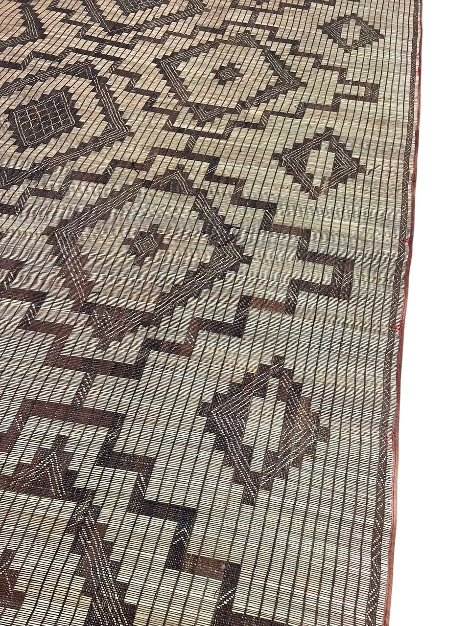 Vintage Touareg mat made of leather and reeds.