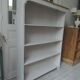 Bookcase in pearl grey waxed finish, light oak waxed top.