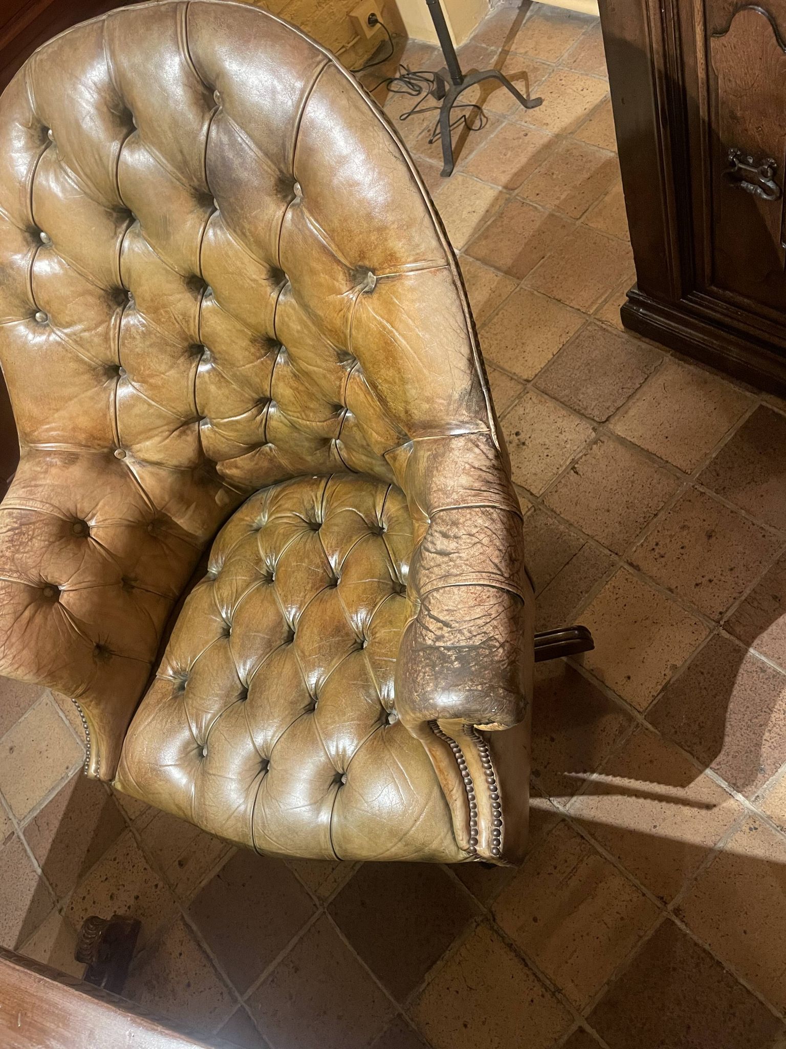 Office chair known as a presidential chair in mahogany and cognac leather.
