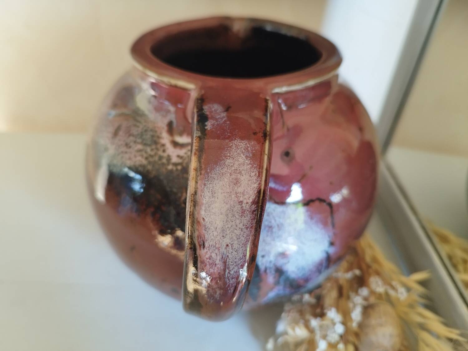 Stoneware pitcher by Matthieu Liévois in shades of red