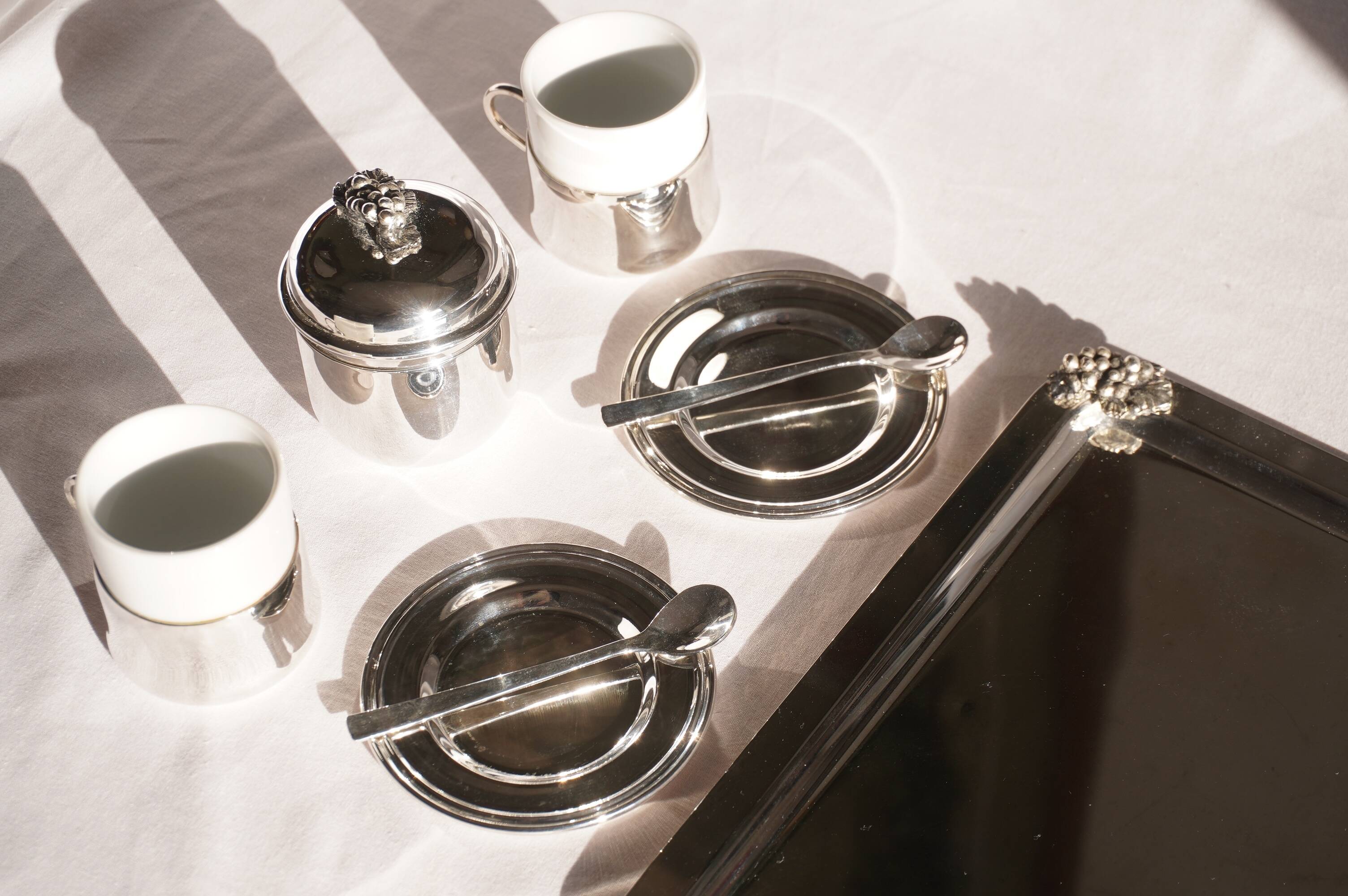 Silver-plated metal coffee service with a grape design.