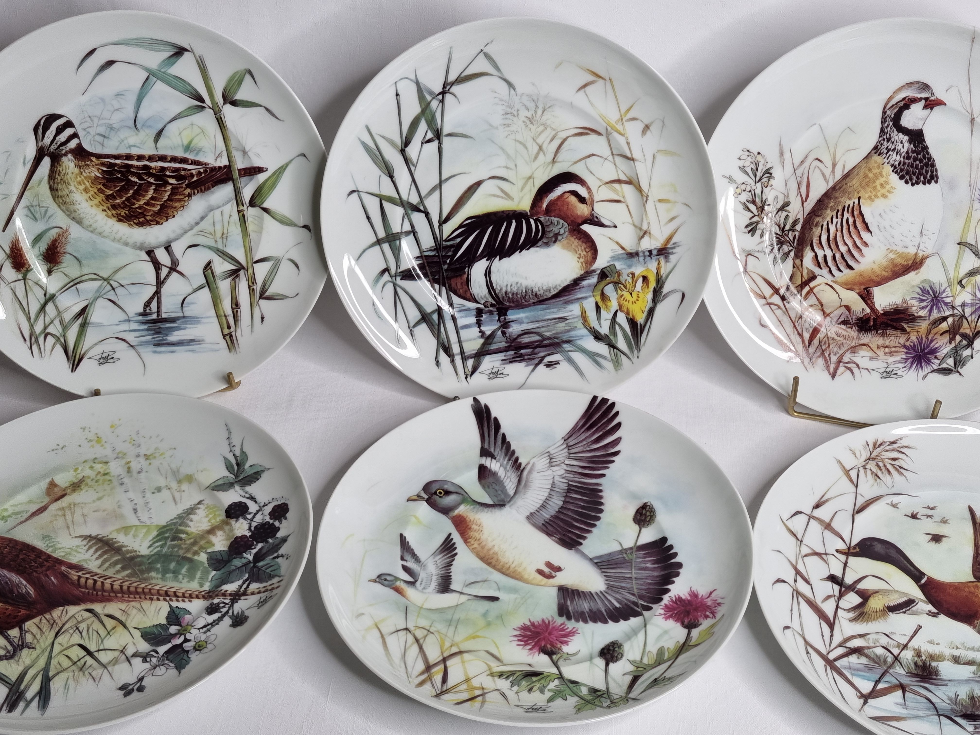 Set of six porcelain plates decorated with birds from Sologne, Limoges, signed, 25 cm