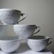 Set of 6 Bernardaud Limoges Louvre model white porcelain cups.