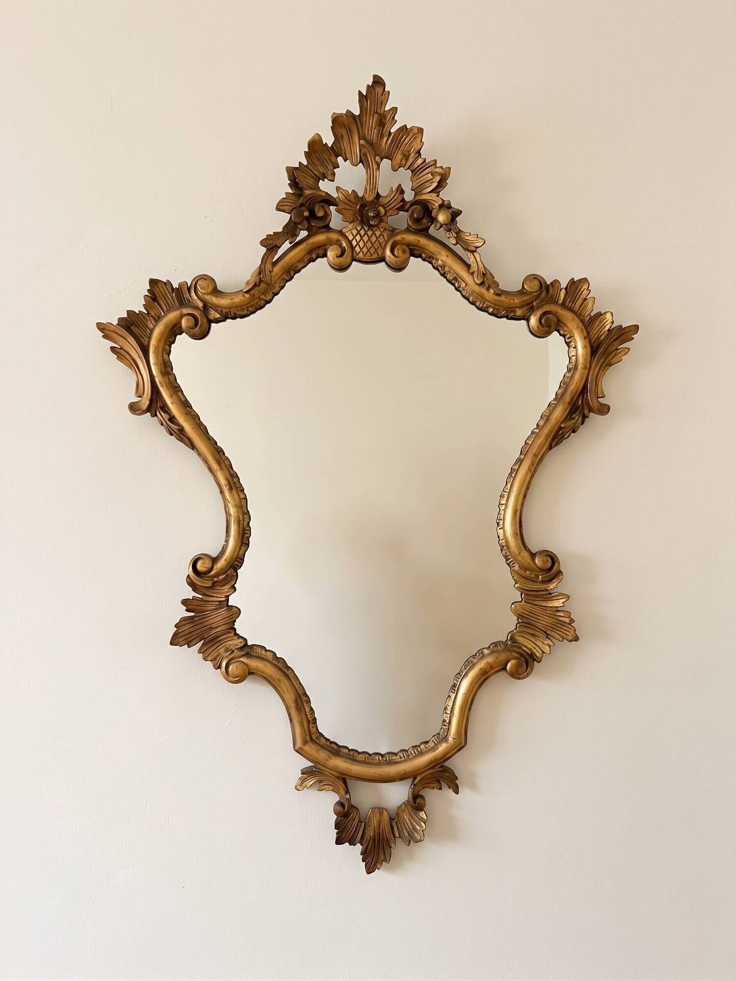 Golden wrought iron console and mirror in rococo style.