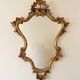 Golden wrought iron console and mirror in rococo style.
