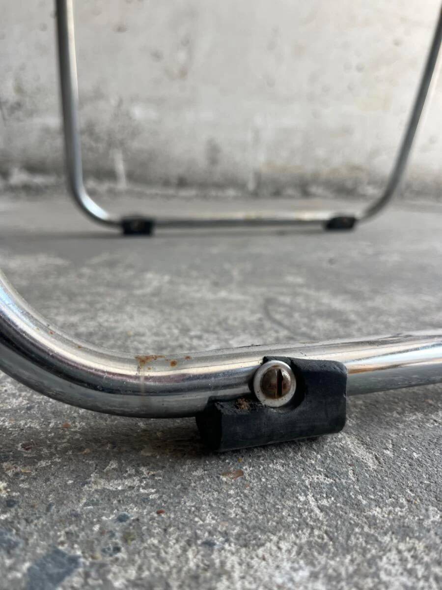 Pair of vintage silver aluminum wire folding chairs with wooden armrests — industrial minimalist