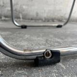 Pair of vintage silver aluminum wire folding chairs with wooden armrests — industrial minimalist